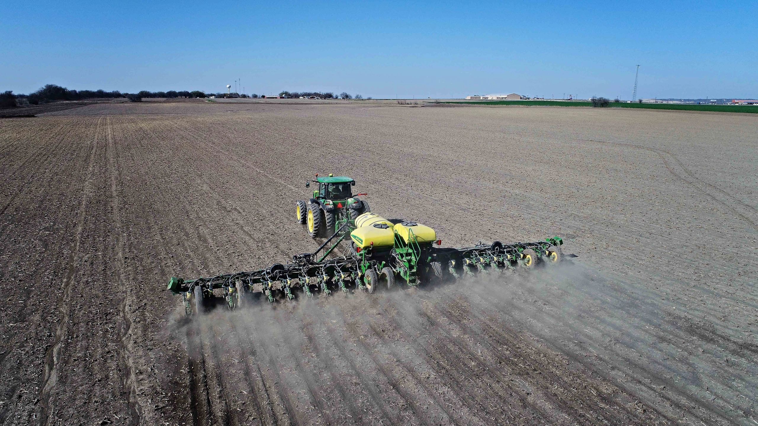 Tractor planting seeds in field
